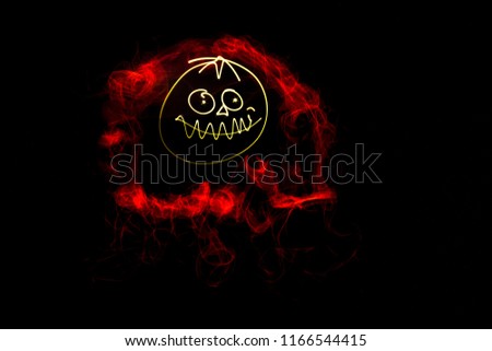 Lightpainting (Photo) - a halloween pumpkin with a red glowing fog around the funny face, on black background