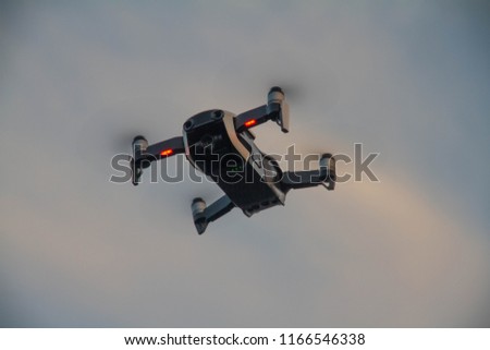 Drone flying in the air with propellors blurred