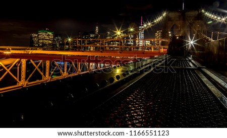 Brooklyn Bridge with view to Manhattan Skyline by night
