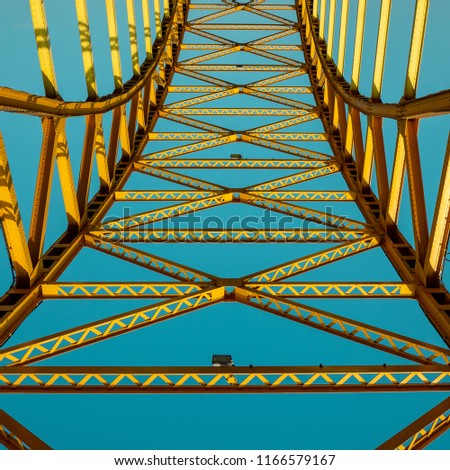 Blue and yellow abstract construction which is part of ordinary bridge.
