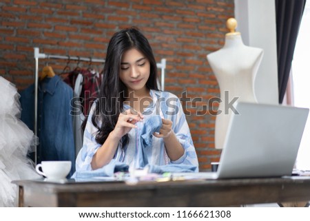 business owner,Fashion designer drawing new sketches collection and use needle in garment collection dummy. young Asian woman dressmaker working in Designers Stylish tailors studio Showroom  workshop