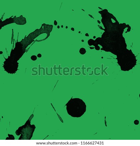 Isolated artistic black watercolor and ink paint splatter textures and decorative elements on green paper background.