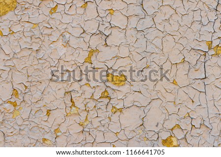 background. cracked wall covering. beige, yellow