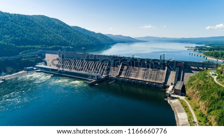 View of a dam of hydroelectric power station in Russia on the Yenisei River, shooting from air Royalty-Free Stock Photo #1166660776