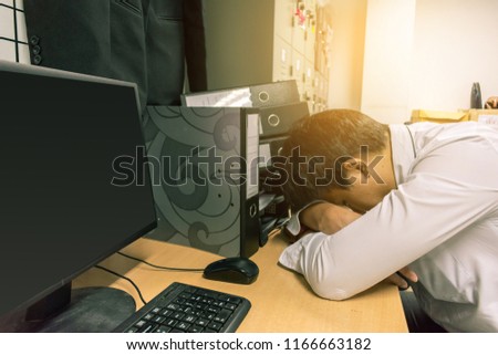 Asian businessman Sleep in office while working computer.Metaphor for fatigue be tired of work to relax image