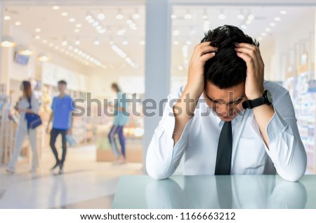 Asian businessman sad sitting or strait business man sitting chair 
Express feeling on city blurred background Metaphor for Success finance
Dealing buying or Insurance image