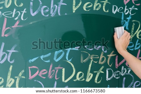Wiping debt on a chalkboard. Royalty-Free Stock Photo #1166673580