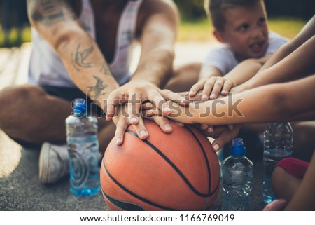 Together is the best. Family after basketball holding hands on basket ball. 