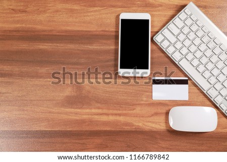 wooden workspace business desk with computer, smartphone and credit card 