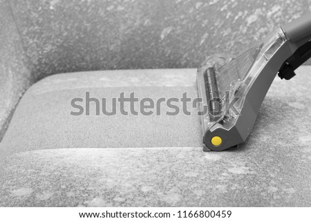 Removing dirt from sofa with upholstery cleaner, closeup Royalty-Free Stock Photo #1166800459