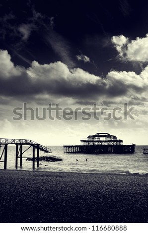 Black and white photograph of the remains of the west pier on brighton beach, Brighton, England, UK