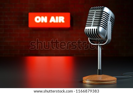 Retro Microphone on table and on air sign on brick wall background