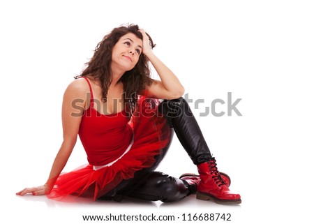 picture of a modern ballerina on the floor looking pensively somewhere up, with her hand on her head