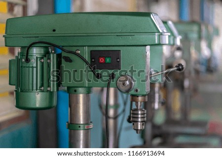 Drilling machine in factory workshop
