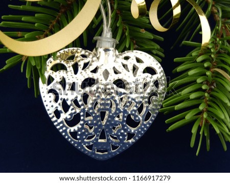 Beautiful christmas decoration, light string silver heart on fir