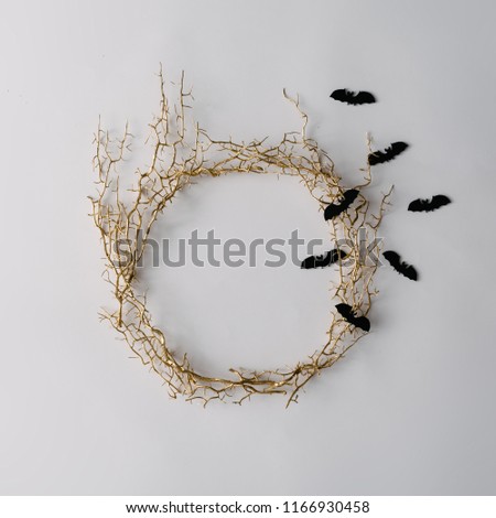 Creative layout made of autumn tree branches with bats. Minimal flat lay. Halloween concept.