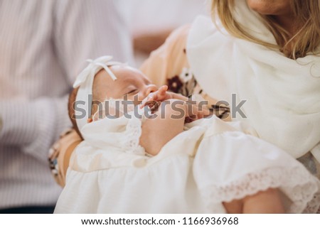 Church. To a little girl and a cross at the ceremony of baptism.Baptizing a child Royalty-Free Stock Photo #1166936968