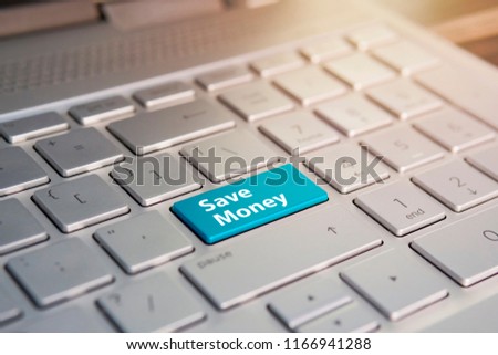 Close up of Save money keyboard button, Color button on the gray silver keyboard of modern ultrabook. caption on the button
