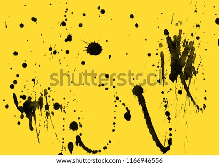 Isolated artistic black watercolor and ink paint splatter textures and decorative elements on yellow paper background.