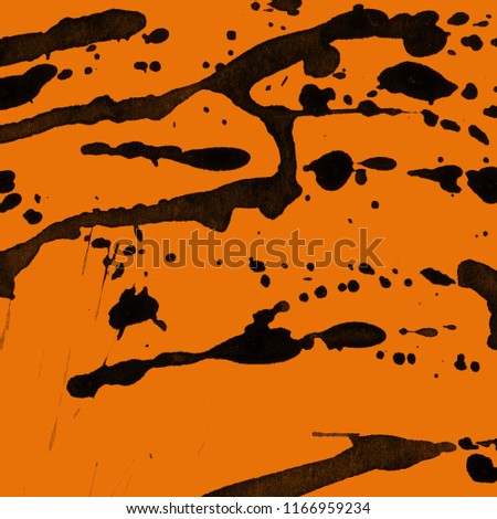 Isolated artistic black watercolor and ink paint splatter textures and decorative elements on orange paper background.