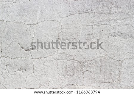 Concrete wall. Deep cracks on the surface