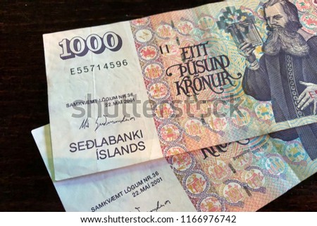 Icelandic cash. Money of Iceland. 1000 Icelandic krona bills on wooden table. Icelandic krona is the national currency of Iceland (kronur)