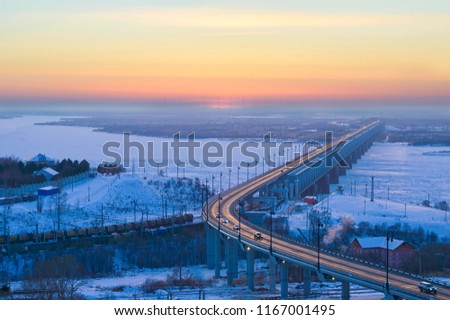 Winter evening on the Amur bridge. Trans siberian railway. Khabarovsk, far East, Russia. Royalty-Free Stock Photo #1167001495