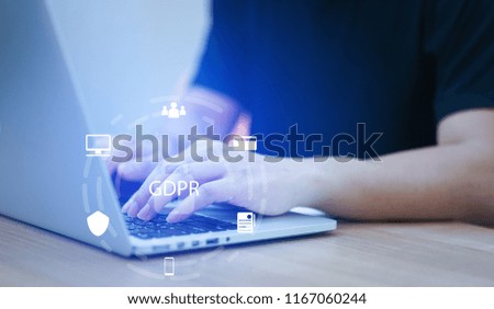 close up asian programmer man working to setting security code on laptop at home office with virtual interface of GDPR (General Data Protection Regulation ) , privacy personal data concept