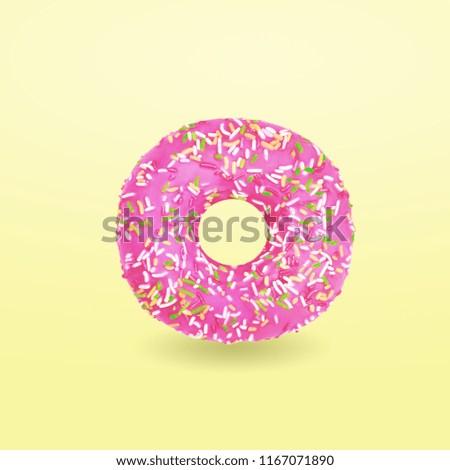Pink donut with icing on yellow background. Glazed donut. Top view. Minimal concept.