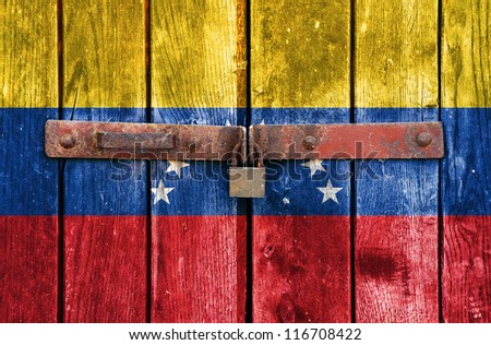 Venezuelan flag on the background of old locked doors