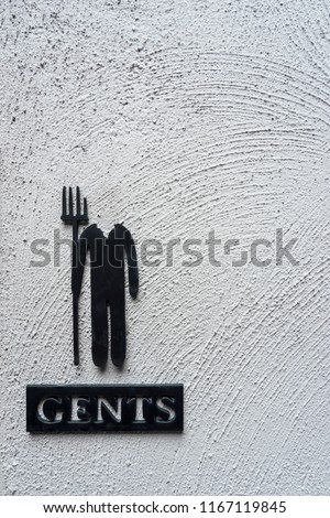 Close up vintage toilet sign on raw concrete wall background