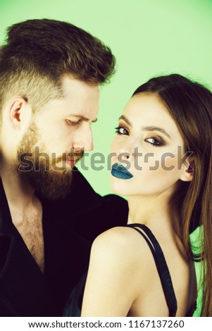 couple. couple of bearded man in coat and pretty woman in black with long hair has fashionable makeup, fashion style people on white background