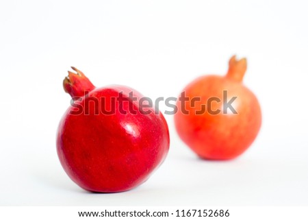 Two Fresh Red Pomegranates fruit isolated on white background