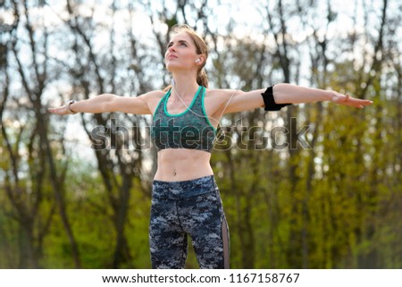 Athletic girl on fitness training in summer park