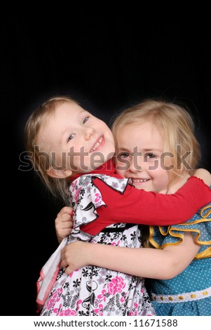 Two blond  toddler girls over black
