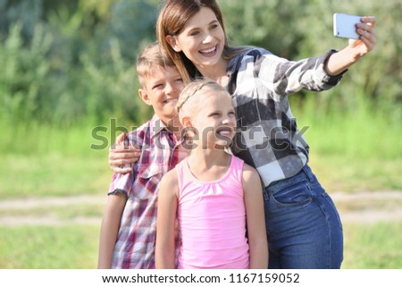 Happy family taking selfie outdoors
