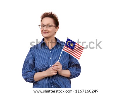 Malaysia flag. Woman holding Malaysia flag. Nice portrait of middle aged lady 40 50 years old with a national flag isolated on white background.