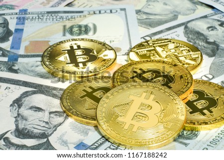 The golden bitcoin on top of dollar banknote background, golden bitcoin symbol of bitcoin crytocurrency from blockchain technology, finance concept