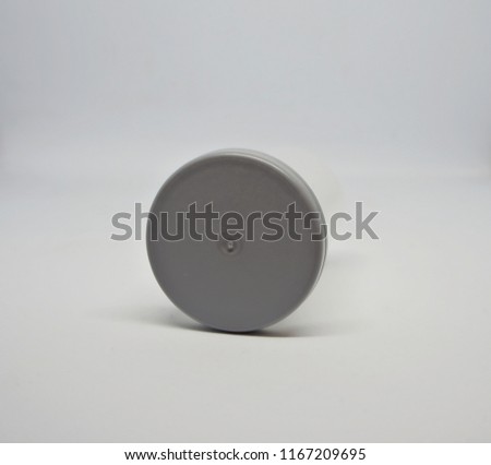 Close up shot on the grey lid of film container with isolated white background