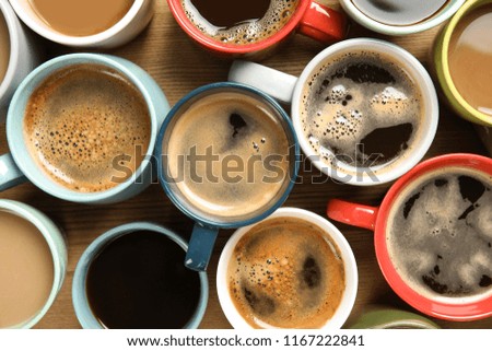 Cups of fresh aromatic coffee on wooden background, top view. Food photography