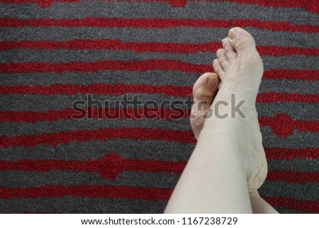 Woman relaxing feet over stripes background during weekend and holiday