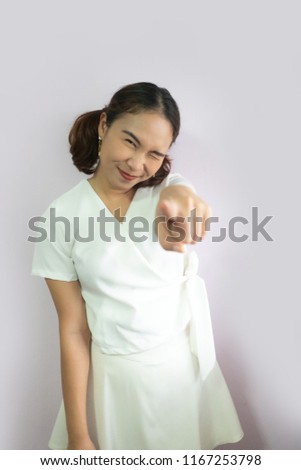 Portrait of a happy young attractive woman finger pointing to camera.