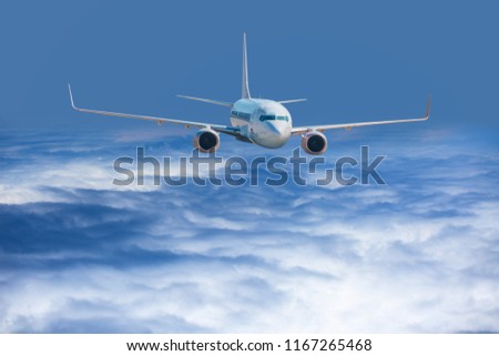 An airplane flying through a dramatic stormy cloud sky