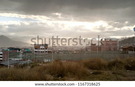 Sunbeams crossing the clouds in the middle of a city