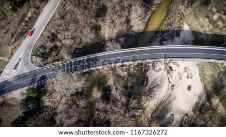 Overhead photography of bridge over river with cars.