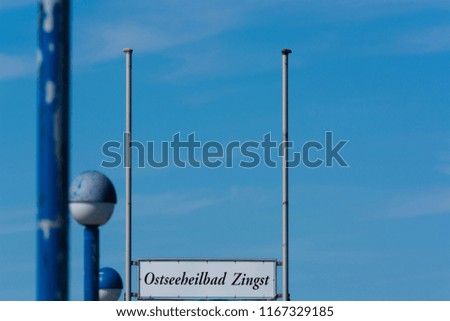 Wooden pier in the Baltic Sea with sign, inscription in german - city Zingst-
Darss Peninsula Fischland-Darss-Zingst Germany