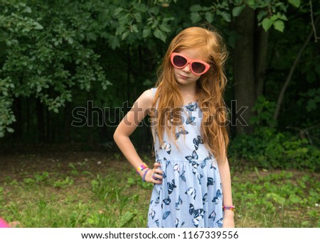 Little Red Haired Girl in Blue Dress Wearing Sunglasses