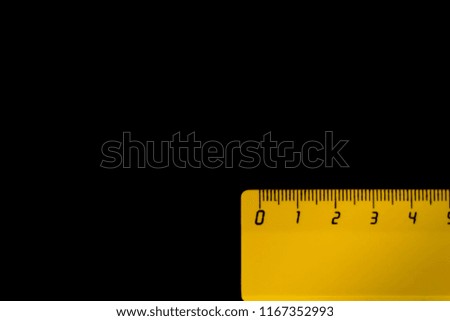 yellow ruler on a black background 5 centimeters