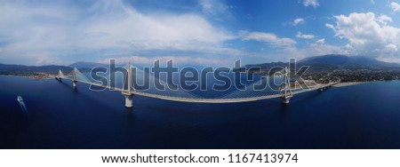 Aerial bird's eye drone panoramic photo of state of the art suspension bridge crossing the sea