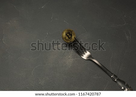  golden bitcoin in silver fork on abstract background